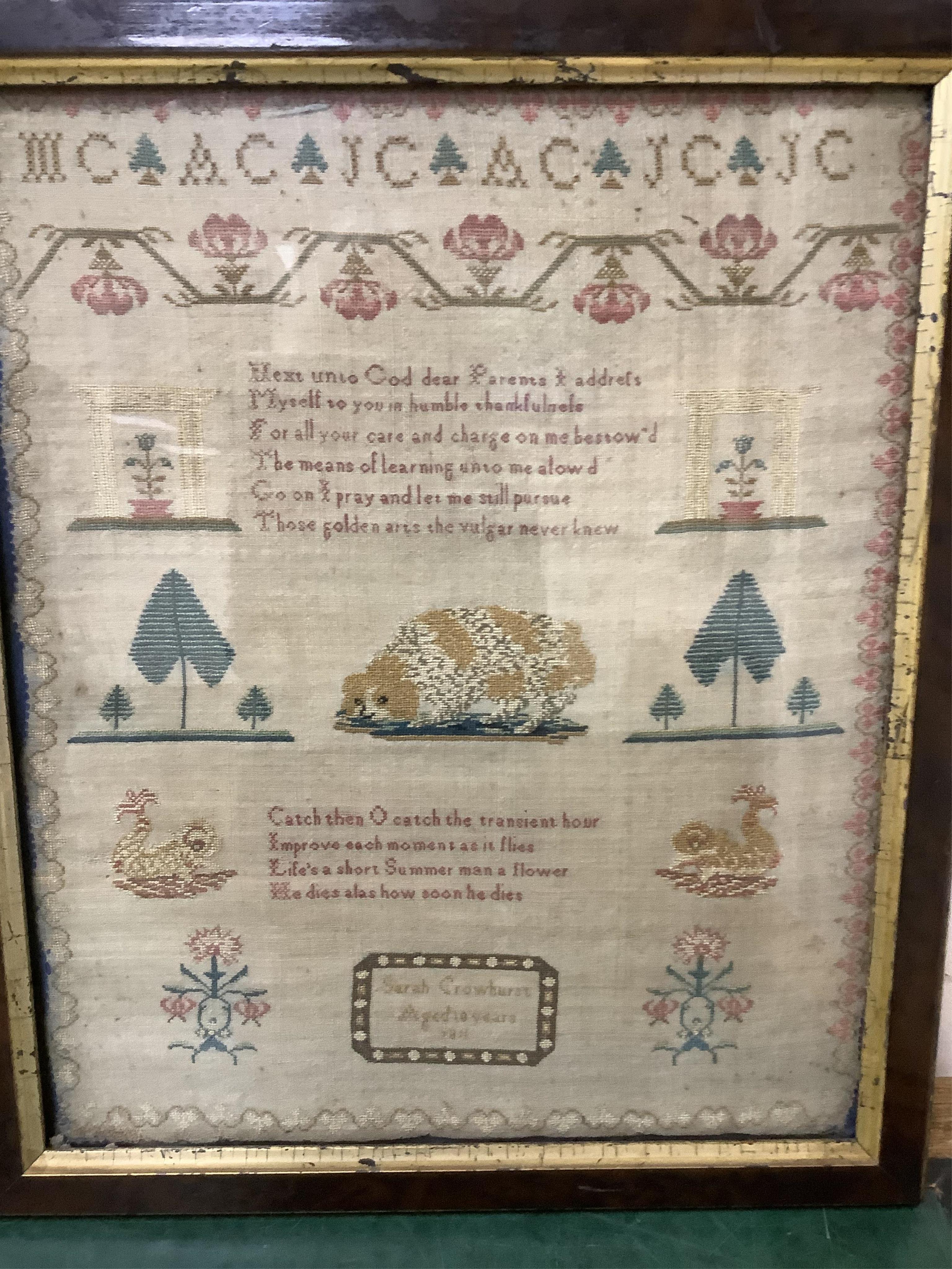 An early 19th century framed sampler by Sarah Crowhurst aged 10 years, dated 1811. Very finely embroidered, on fine linen, with a line of alphabet, then a religious verse and a large central spaniel motif between stylist